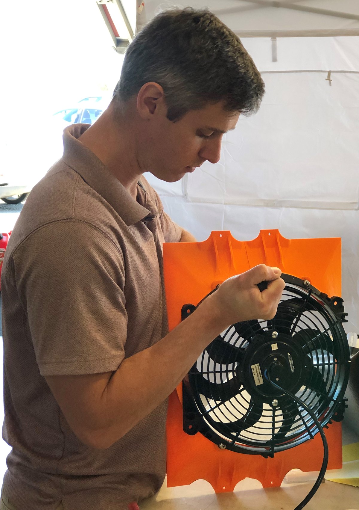 a man working on the radiation fan