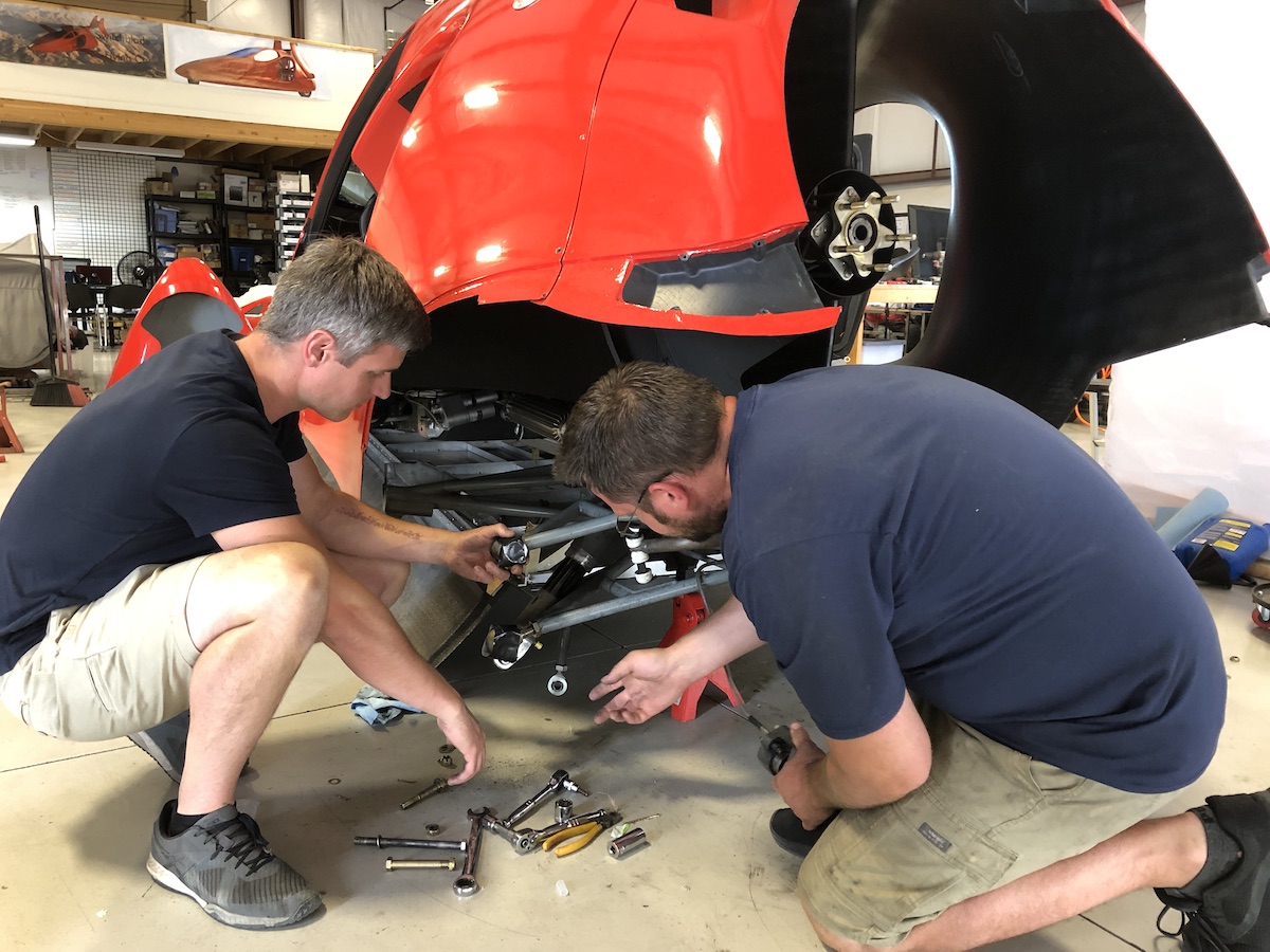 two men working on the switch blade suspension
