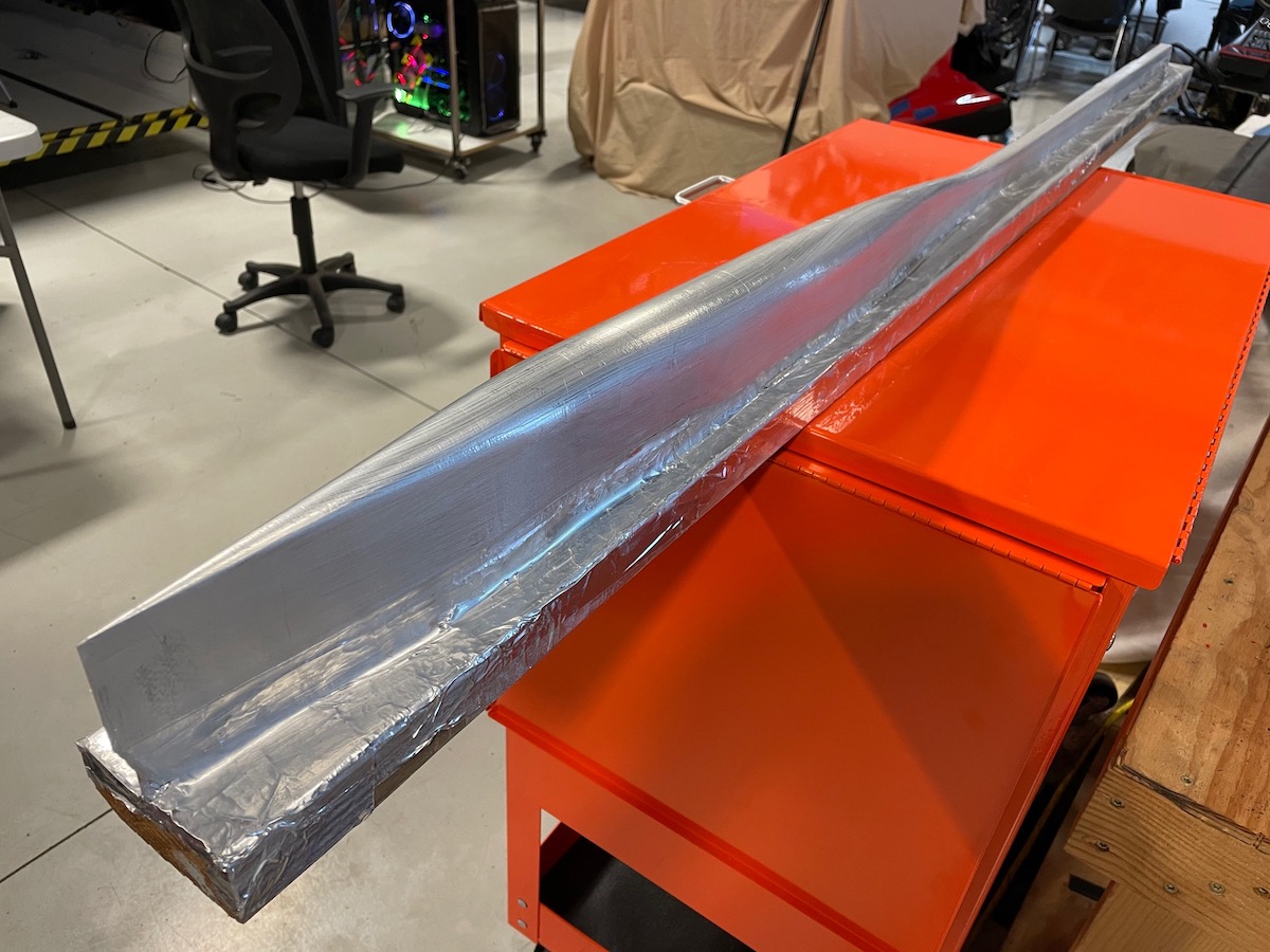 IMG_0020 image of a red workbench with a silver metal beam across it