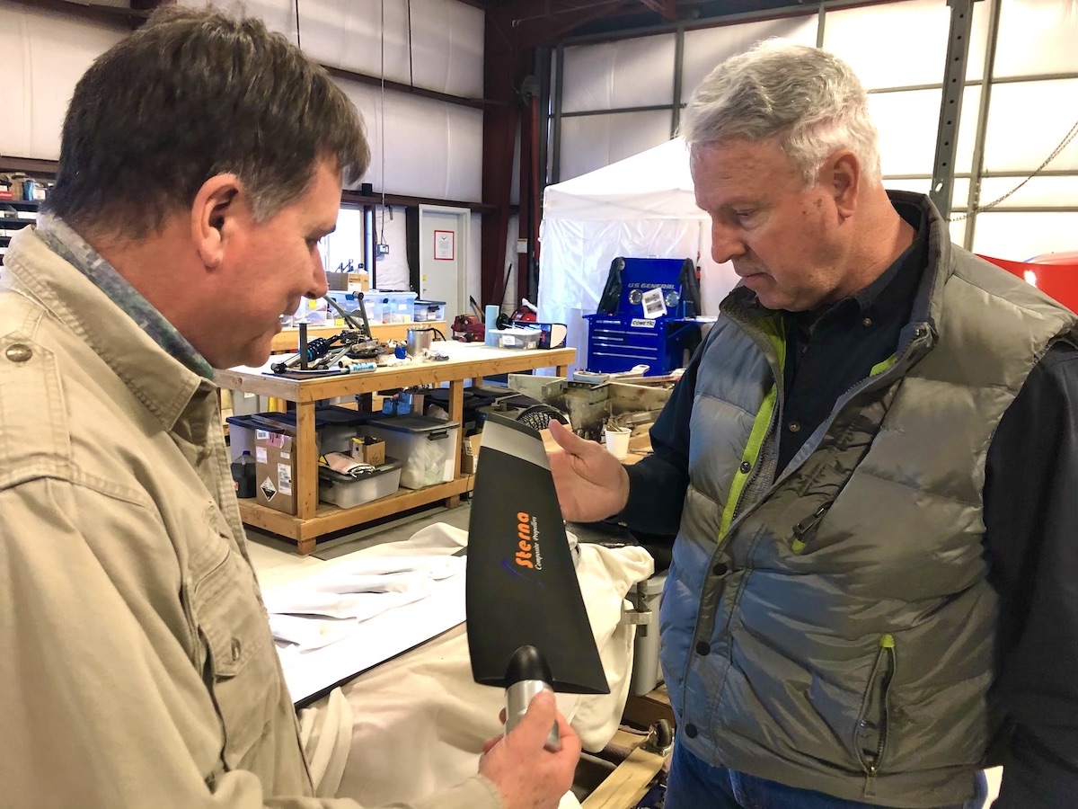 Sam & Capt Ron looking at new prop blade 1.09.21 two people looking at a propeller blade