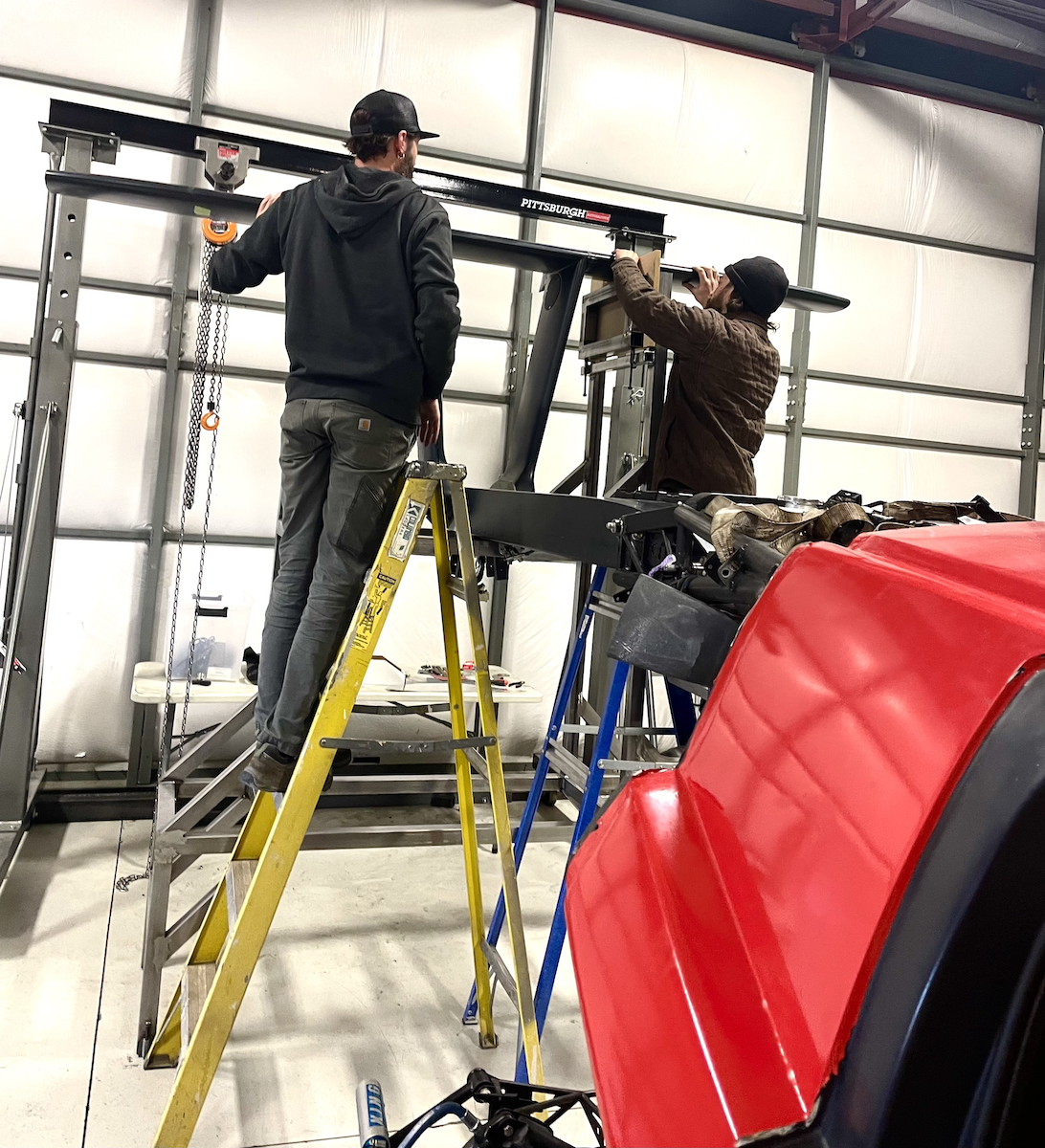 leveling the tail 2.25.22 two people standing on a gantry leveling the tail of the switchblade flying car