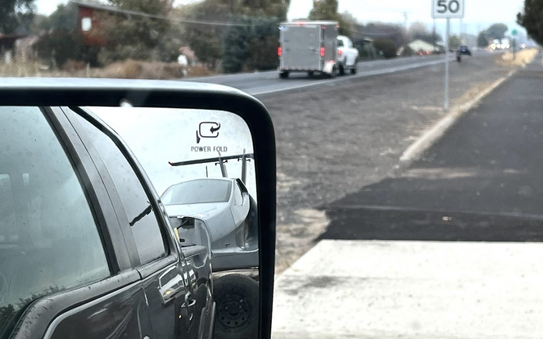 IS THAT A FLYING CAR IN THE SIDE VIEW MIRROR?